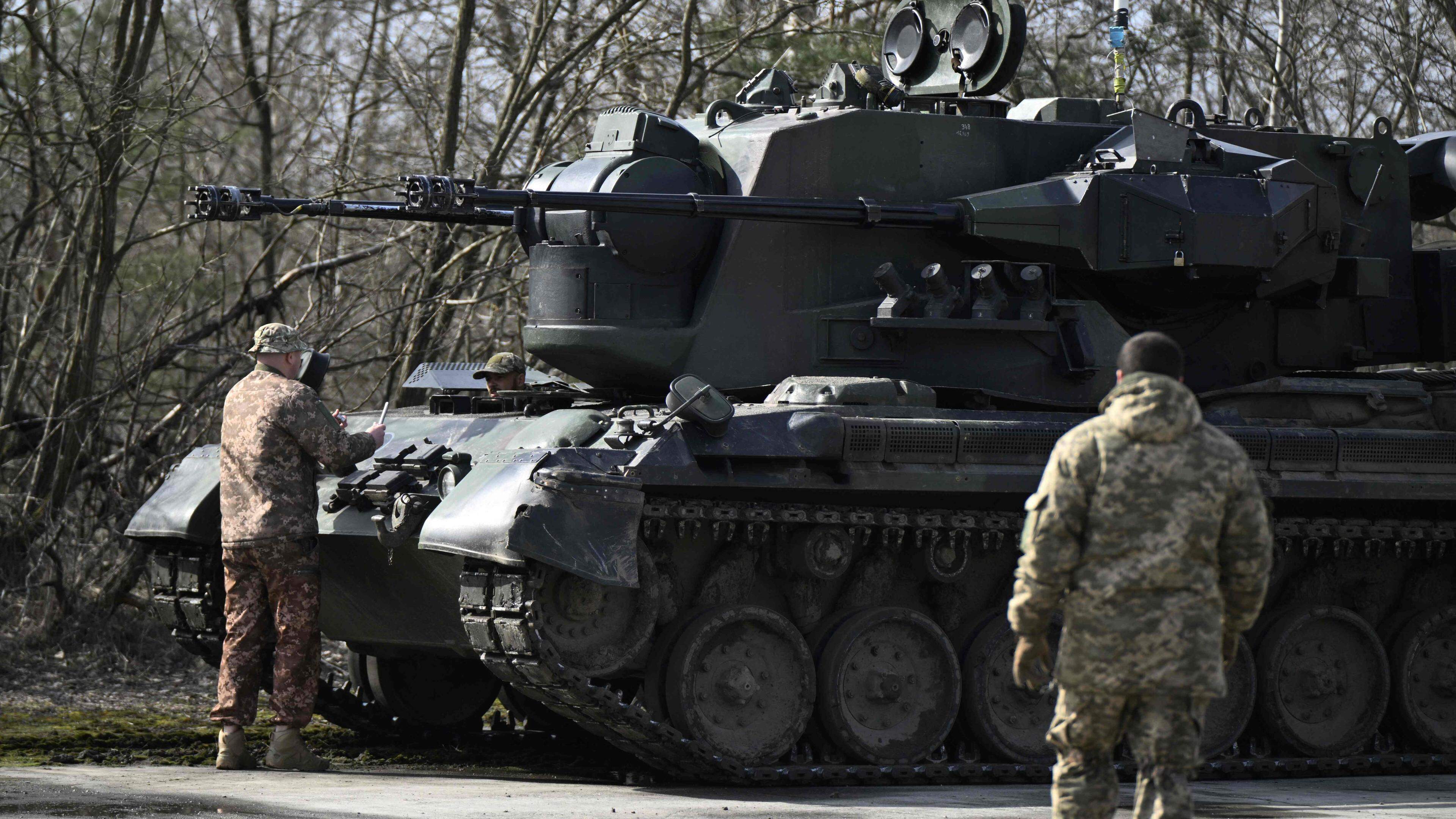 Ukrainian servicemen, crew members of a German-made self-propelled anti-aircraft (SPAAG), better known as the Flakpanzer Gepard, prepare for a combat duty in Kyiv region, on March 21, 2024, amid the Russian invasion of Ukraine. (Photo by Genya SAVILOV / AFP)
