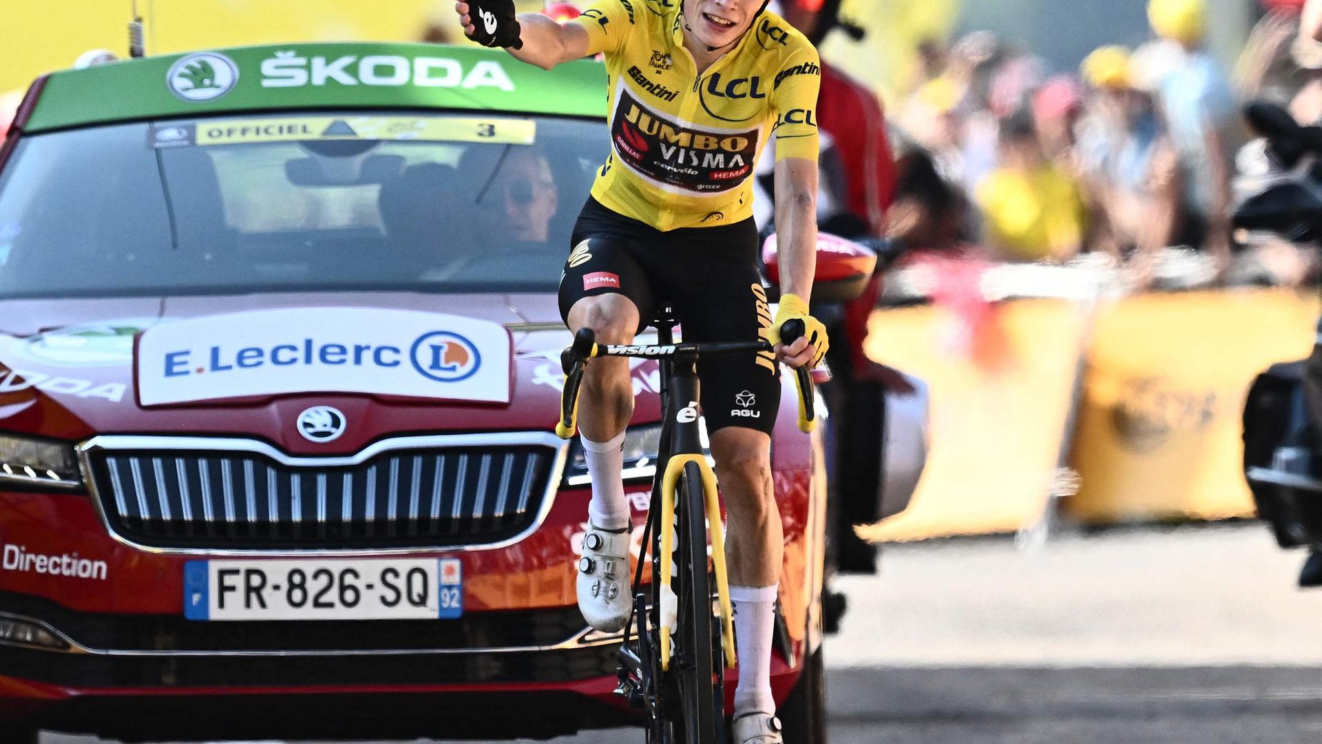 Jumbo-Visma team's Danish rider Jonas Vingegaard wearing the overall leader's yellow jersey celebrates as he cycles to the finish line to win the 18th stage of the 109th edition of the Tour de France cycling race, 143,2 km between Lourdes and Hautacam in the Pyrenees mountains in southwestern France, on July 21, 2022. (Photo by Marco BERTORELLO / AFP)