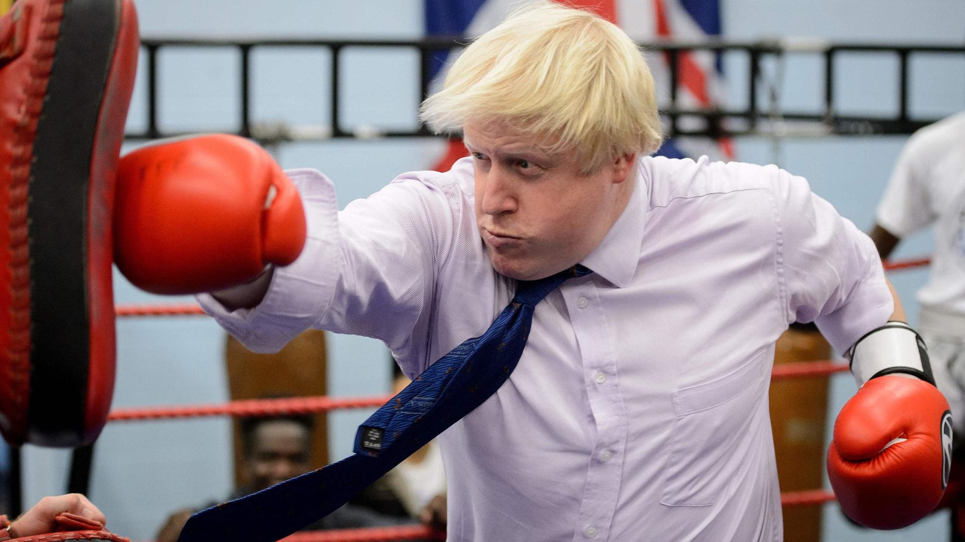 (FILES) In this file photo taken on October 28, 2014 Mayor of London Boris Johnson boxes with a trainer during his visit to Fight for Peace Academy in North Woolwich, London. - Former London mayor Boris Johnson on July 23, 2019 won the race to become Britain's next prime minister, defeating Foreign Secretary Jeremy Hunt in the Conservative Party leadership contest. (Photo by LEON NEAL / AFP)