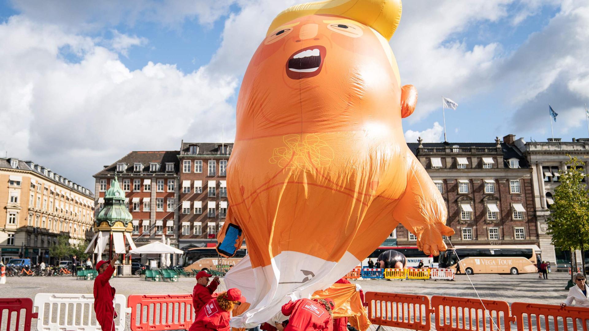 Demonstrators protest with an inflated Baby-Trump balloon at Kongens Nytorv in Copenhagen, Denmark, on September 2, 2019. - Though US President Donald Trump had canceled the state visit to Denmark scheduled for September 2 and 3, 2019, demonstrators carried out their planned protests. (Photo by Niels Christian Vilmann / Ritzau Scanpix / AFP) / Denmark OUT