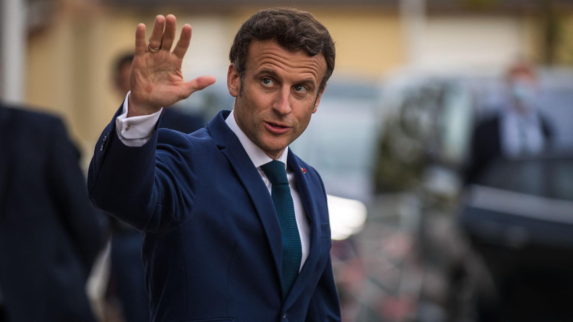 French President Emmanuel Macron gestures a he leaves Percy military hospital after his visit to meet soldiers injured during external operations and caregivers in Clamart, near Paris, France, on April 28, 2022. (Photo by Christophe PETIT TESSON / POOL / AFP)