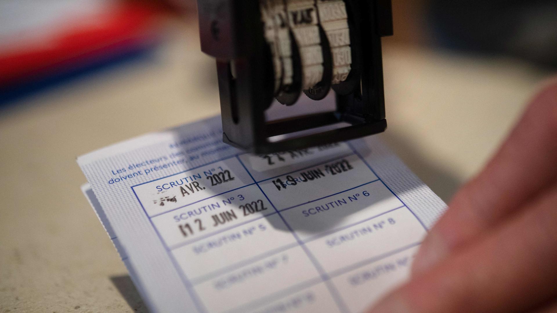 An French electoral card is stamped in Carhaix-Plouguer, western France, during the second round of French legislative elections, on June 19, 2022. (Photo by FRED TANNEAU / AFP)