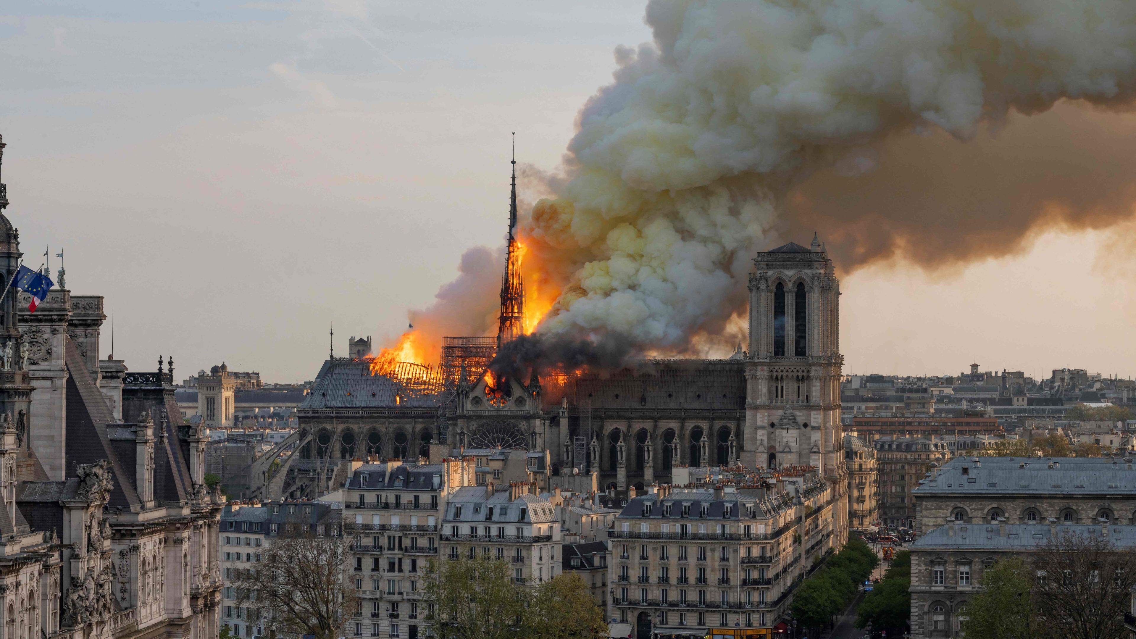 Smoke billows as flames burn through the roof of the Notre-Dame de Paris Cathedral on 15 April, 2019