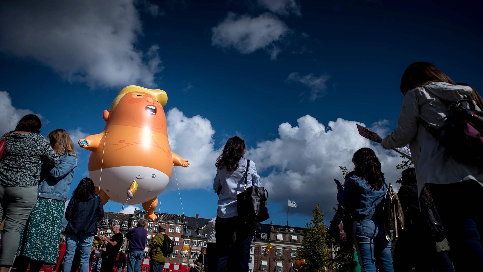 Demonstrators protest with an inflated Baby-Trump balloon at Kongens Nytorv in Copenhagen, Denmark, on September 2, 2019. - Though US President Donald Trump had canceled the state visit to Denmark scheduled for September 2 and 3, 2019, demonstrators carried out their planned protests. (Photo by Mads Claus Rasmussen / Ritzau Scanpix / AFP) / Denmark OUT