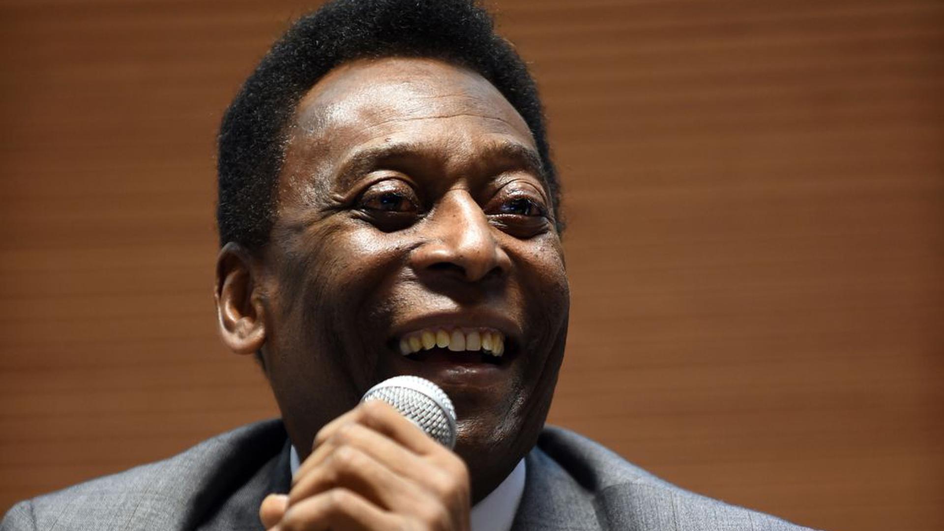 Brazilian football star Pele (R) speaks during the launch of the Portuguese version of The Better Life Index developed by The Organisation for Economic Co-operation and Development (OECD) in Sao Paulo, Brazil, on June 9, 2014 prior to the star of the FIFA 2014 World Cup. The Index allows to compare well-being across countries, based on 11 topics the OECD has identified as essential, in the areas of material living conditions and quality of life. AFP PHOTO/EITAN ABRAMOVICH