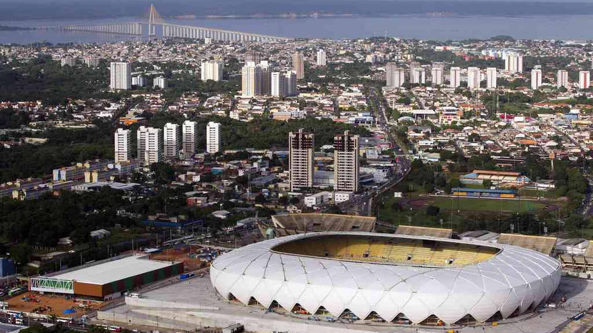 The Arena Amazonia soccer stadium is seen in this aerial view taken two days before its scheduled inauguration, in Manaus, in this file picture taken March 7, 2014. Manaus is best known as a stopover for travelers on the way to and from eco tours in Brazil's Amazon rainforest, but in many ways it is more like a bustling frontier outpost of the modern, industrial world on a distant, jungle planet. Soccer fans should be prepared to sweat when Manaus hosts four World Cup games in June in the new $300 million stadium that looks destined to become a white elephant. Arena Amazonia is the venue for England vs Italy, Cameroon vs Croatia, USA vs Portugal and Honduras vs Switzerland. To match Trip Tips TRAVEL-MANAUS/     REUTERS/Bruno Kelly/Files (BRAZIL - Tags: SPORT SOCCER WORLD CUP TRAVEL CITYSCAPE)