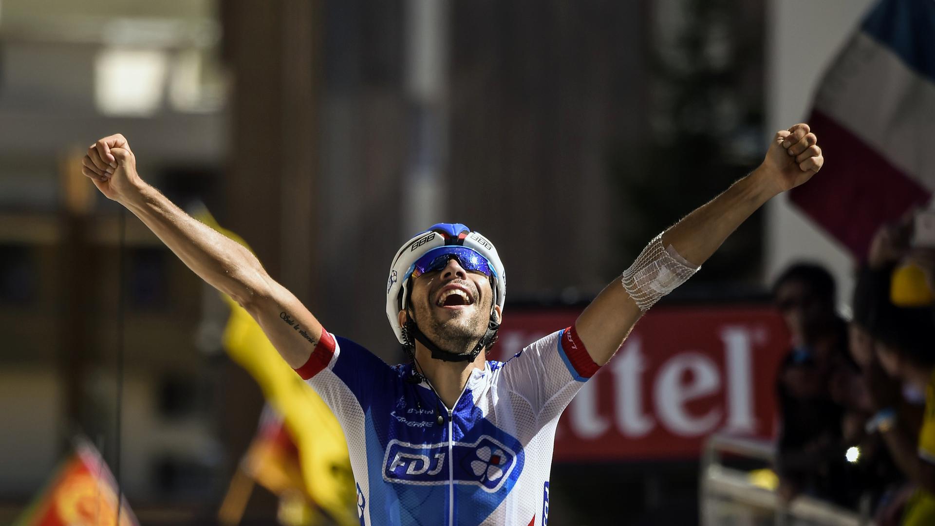 France's Thibaut Pinot celebrates as he crosses the finish line at the end of the 110,5 km twentieth stage of the 102nd edition of the Tour de France cycling race on July 25, 2015, between Modane Valfrejus and Alpe d'Huez, French Alps.  AFP PHOTO / ERIC FEFERBERG